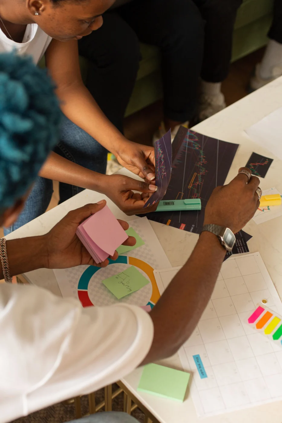 Colleagues organizing project ideas with charts and colorful notes