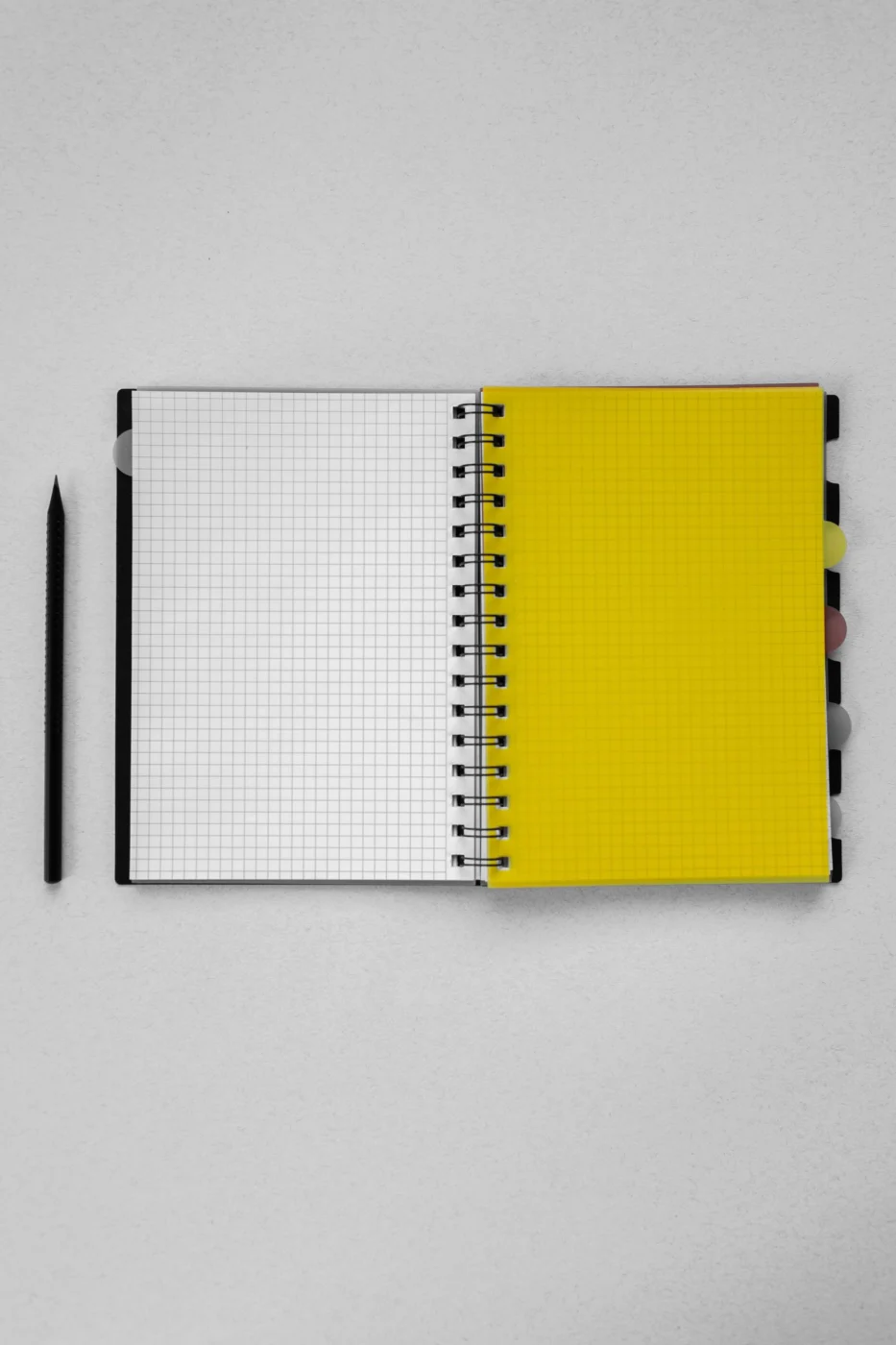 An open graph-paper notebook and pencil for organizing website requirements
